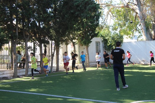 Elèves de l'école Laghmani entrain de faire une activité sportive avec leur coach